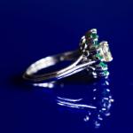 Platinum ring with diamond and emeralds