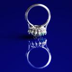 Platinum ring with diamond and emeralds