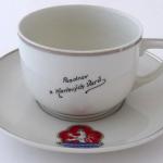Cup with a saucer and the emblem of the city 