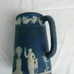 Blue jug with white figurines