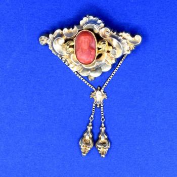 Gold brooch with coral miniature