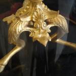 The bronze clock with candlesticks under glass bel The bronze clock with candlesticks under glass bel