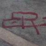 City street, with tram and figures - monogram E. R City street, with tram and figures - monogram E. R