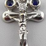 White gold cross with diamond and paired blue sapp White gold cross with diamond and paired blue sapp