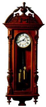 A clock in a wooden box on a wall A clock in a wooden box on a wall