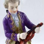 Boy tuning a violin - Passau, Germany Boy tuning a violin - Passau, Germany