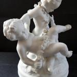 Sculpture of three children with a garland of flow Sculpture of three children with a garland of flow