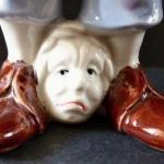 Statue of a man with his head at his feet Statue of a man with his head at his feet