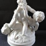 Sculpture of three children with a garland of flow Sculpture of three children with a garland of flow