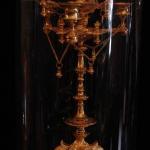 The bronze clock with candlesticks under glass bel The bronze clock with candlesticks under glass bel