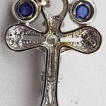 White gold cross with diamond and paired blue sapp White gold cross with diamond and paired blue sapp