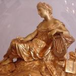 The bronze clock with candlesticks under glass bel The bronze clock with candlesticks under glass bel