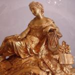 The bronze clock with candlesticks under glass bel The bronze clock with candlesticks under glass bel