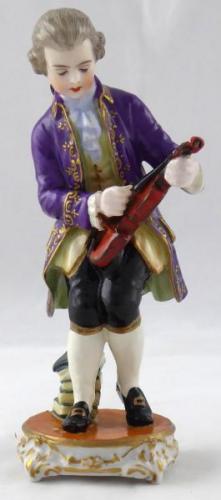 Boy tuning a violin - Passau, Germany Boy tuning a violin - Passau, Germany