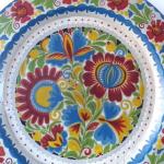 Wooden plate with painted colorful flowers