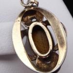 Silver and gilded pendant with a tigers eye