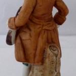 Hand-painted statue of a musician with mandolin
