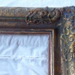 Patinated gold frame with decorations, square shap