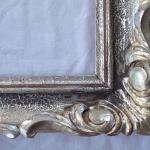 Patinated silver frame with carving