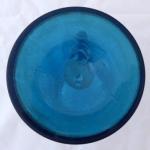 Blue glass pitcher with poppy flower