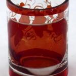 Small glass with medallion and vine leaves