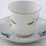 Coffee cup with blue flowers, cob and leaves