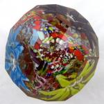 Colourful paperweight with three flowers in a bask