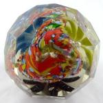 Colourful paperweight with three flowers in a bask
