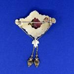 Gold brooch with coral miniature