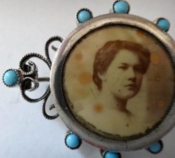 Silver brooch with photos and turquoise