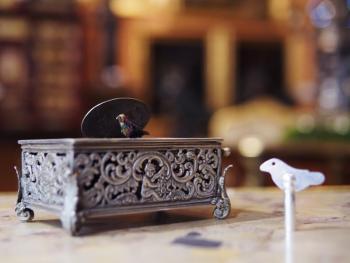 Silver music box with a bird