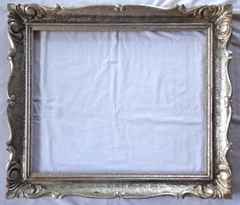 Patinated silver frame with carving