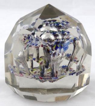 Glass paperweight with facets and colourful flower